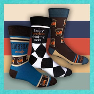 Image of three socks one saying bourbon rocks, one fancy drinking socks and one with bourbon glass