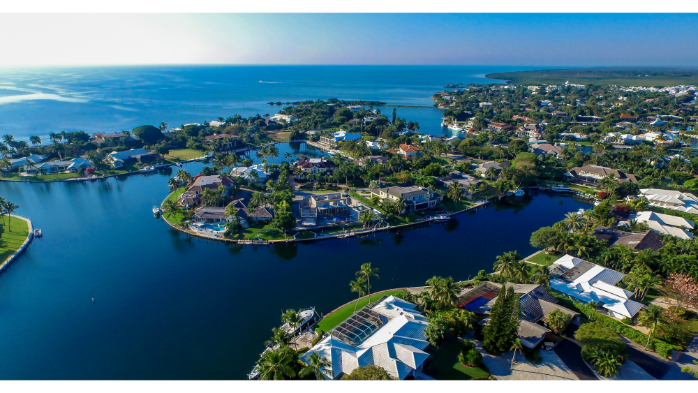 Aerial view of luxury waterfront homes, canals, and tropical coastline in the Florida Keys.
