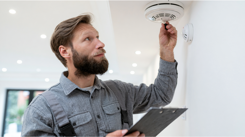 Professional pest control technician treating a residential rental property for pest prevention.