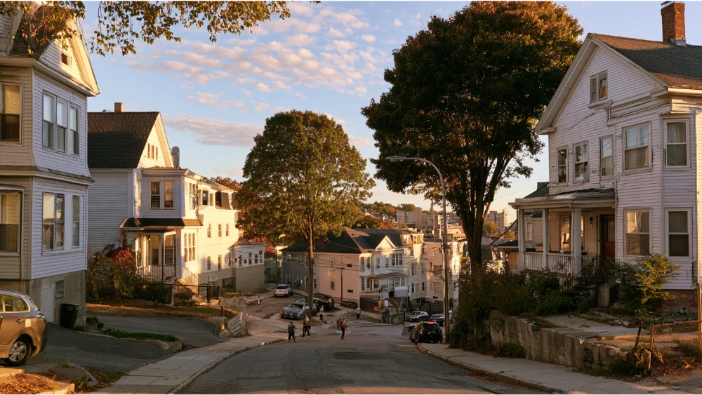 Residential Worcester neighborhood showing historic three-decker homes and everyday street life