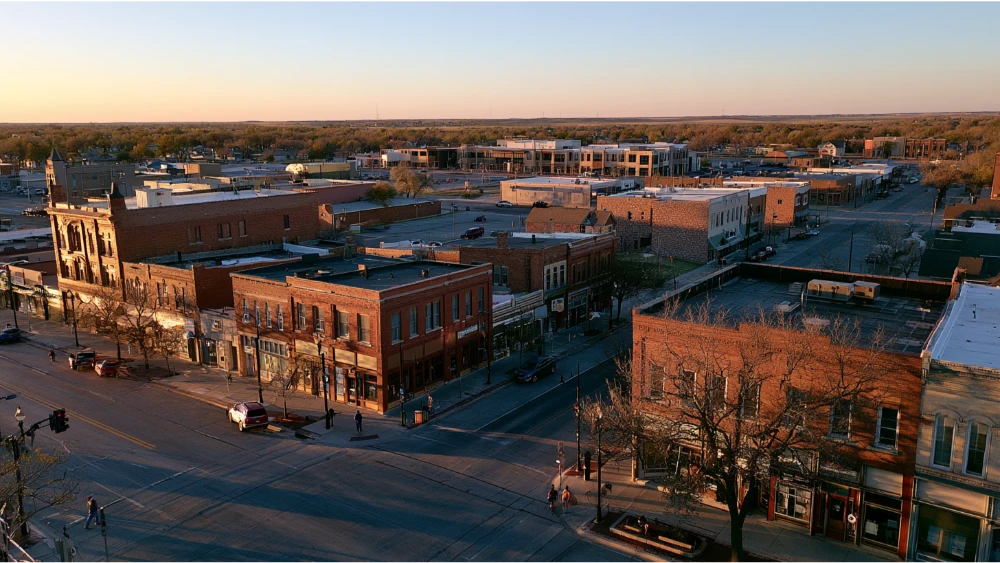 A typical Kearney, Nebraska, street with local businesses, residential buildings, everyday traffic, and the city's open central Nebraska surroundings.
