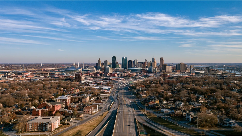 Aerial view of Kansas City area with a visible boundary like a river or highway dividing two sides of the metro.