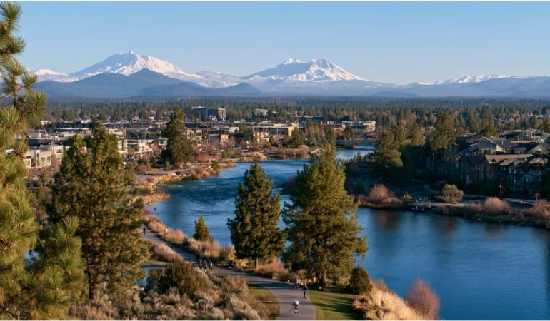 People enjoying an outdoor dining area in Bend, Oregon, with local food vendors, neighborhood restaurants, pine trees, and a relaxed Central Oregon atmosphere.