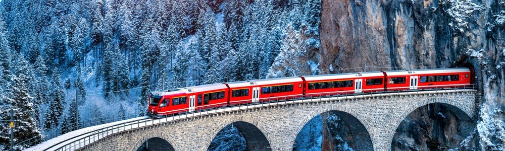 Aerial,View,Of,Train,Passing,Through,Famous,Mountain,In,Filisur,