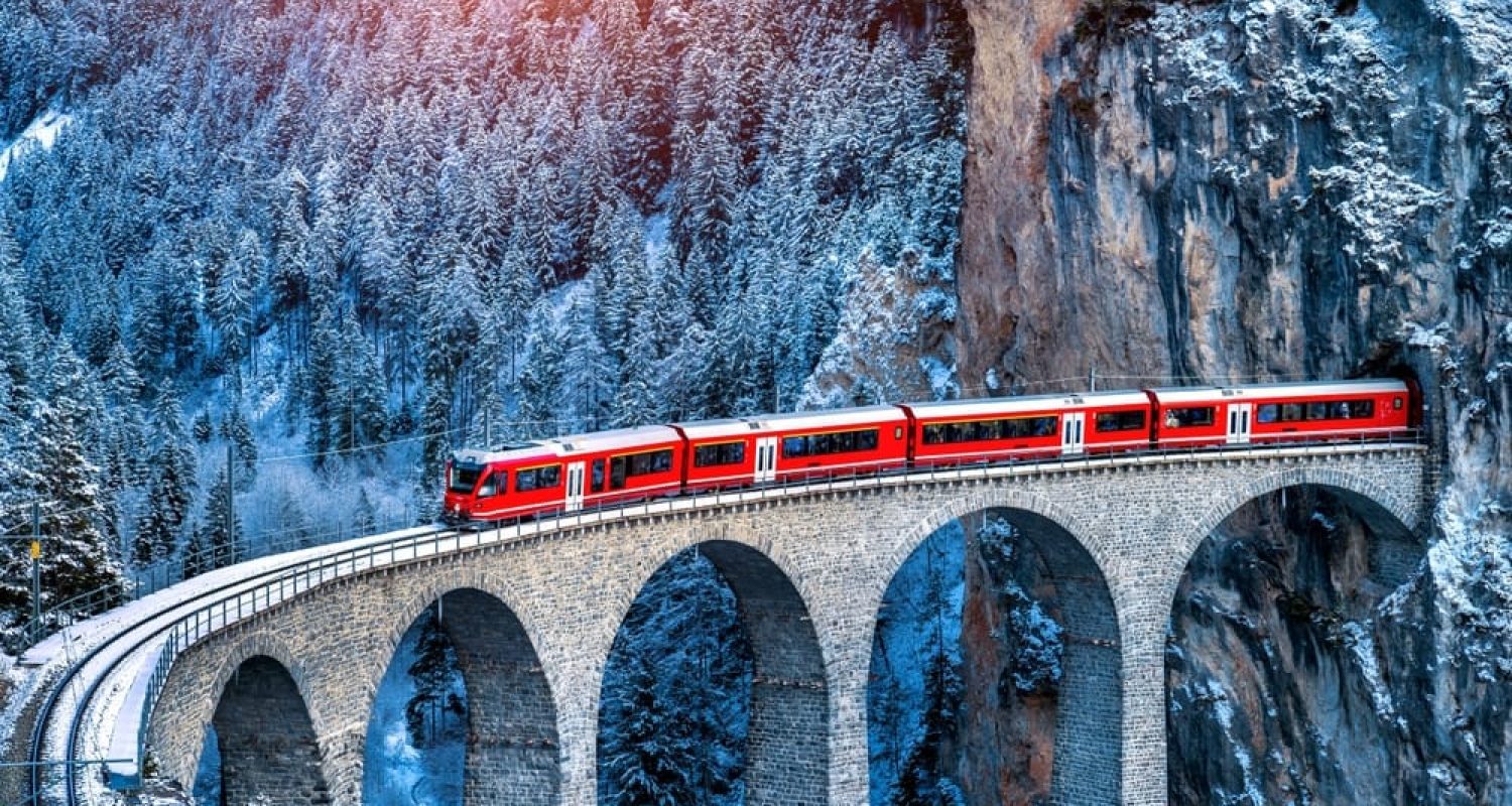 Aerial,View,Of,Train,Passing,Through,Famous,Mountain,In,Filisur,